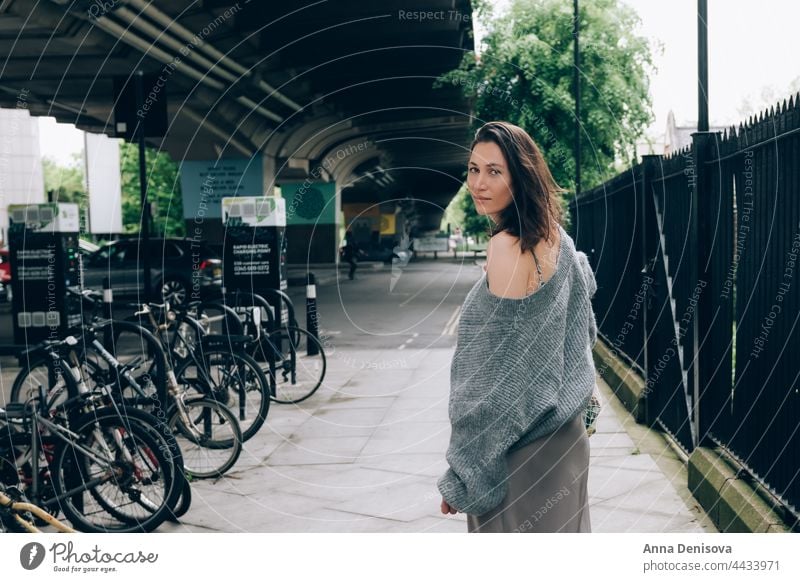 Young Lady on streets of London fashionable woman mesh bag sweater silk skirt gray trend stylish model female outdoor pretty beautiful caucasian trendy glamour