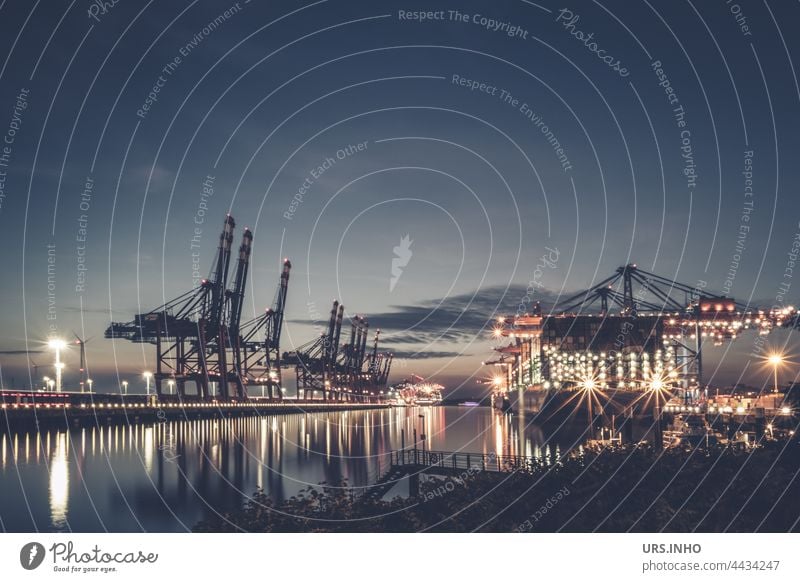 typical port scene at dusk with illuminated container ships and port cranes reaching high into the sky Harbour Harbour scene Container Container ship Industry