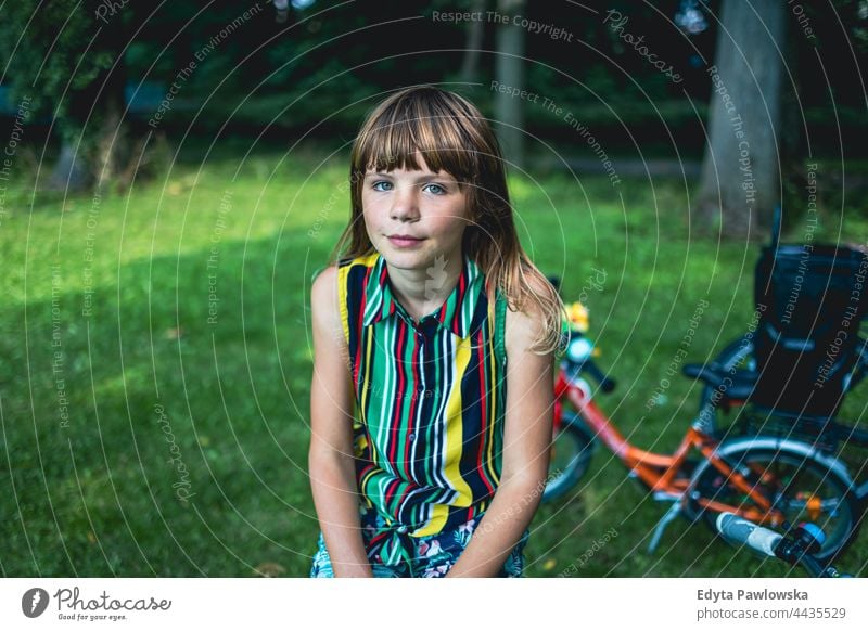 Portrait of a girl with a bicycle in a park tree nature outdoors people adventure trees spring woods lifestyle recreation caucasian beautiful beauty bike child