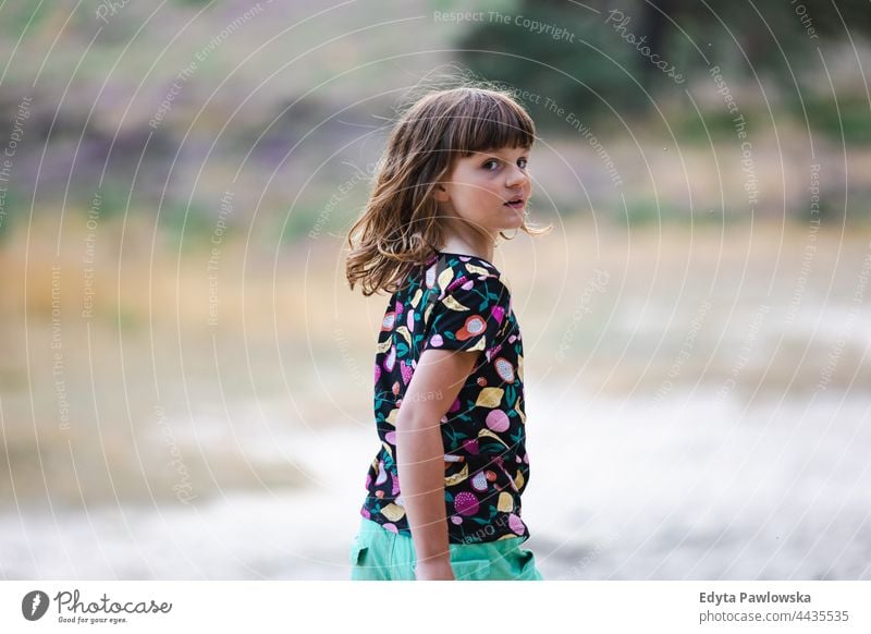 Little girl on a meadow full of heather at sunset grass field rural countryside adventure Wilderness wild
hair vacation travel active summertime day freedom