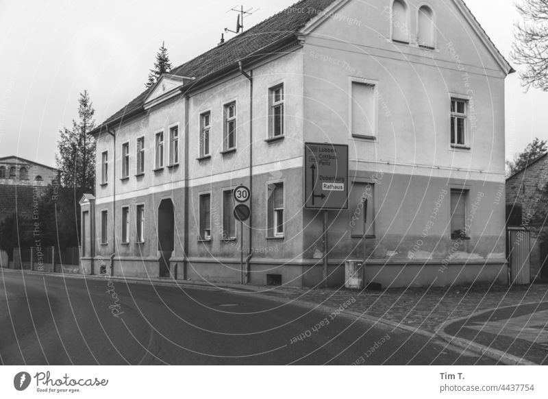 a road through a town with a large traffic sign Brandenburg Signage Road sign Signs and labeling Transport Road traffic Warning sign Exterior shot