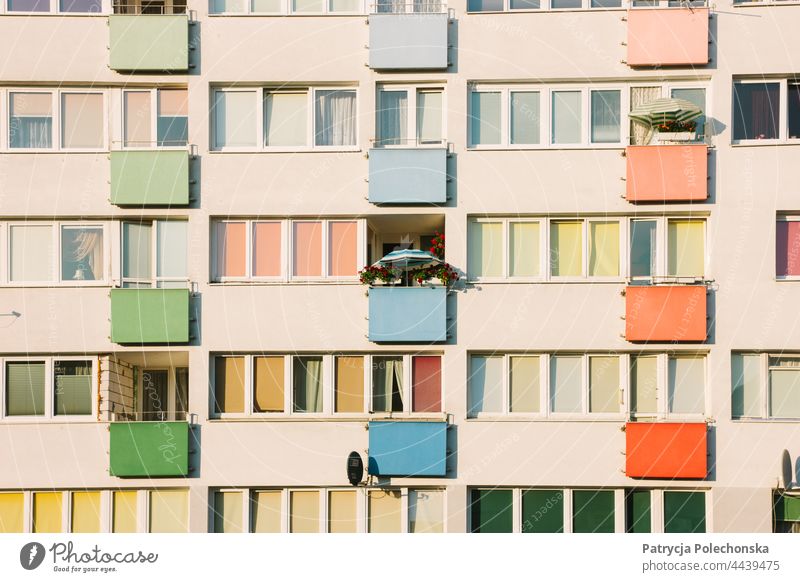 Pastel pink apartment building with a parasol on one of the balconies pastel Pink Apartment Building Architecture colorful Block Eastern Europe closeup