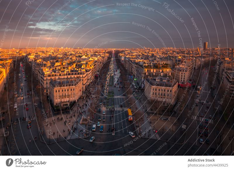 Cityscape with roads and buildings under sunset sky cityscape cloudy architecture route shiny direction evening facade residential glow colorful remote height