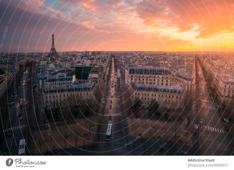 Cityscape with roads and buildings under sunset sky cityscape cloudy architecture route shiny direction evening facade residential glow colorful remote height