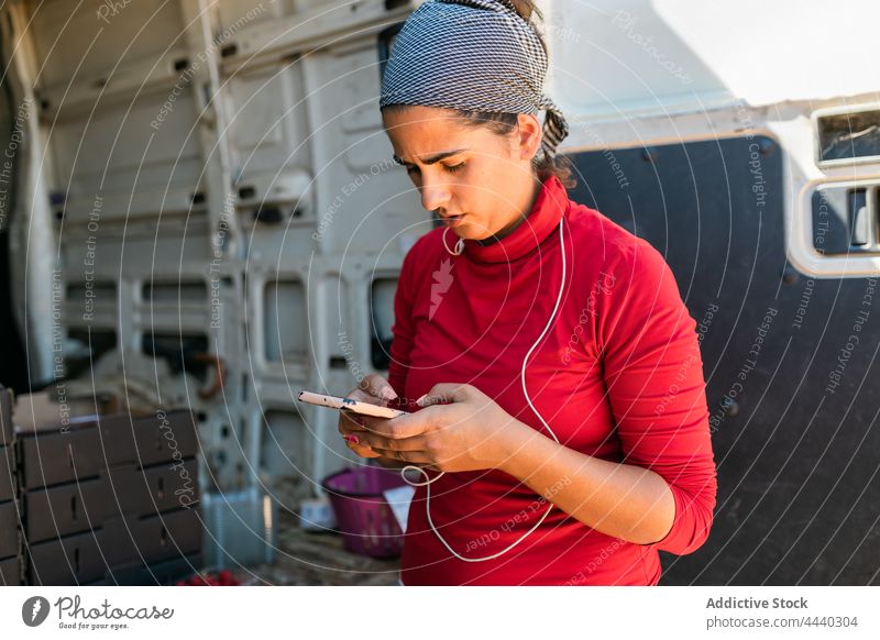 Serious farmer texting on smartphone during work woman using watch message serious search browsing job female gadget surfing internet connection mobile