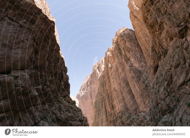 Rough mountain under blue sky in sunlight nature highland geology landscape gorge barren massive majestic dry ridge kingdom scenic morocco magnificent rugged