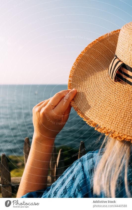 Crop tourist in straw hat admiring ocean traveler contemplate sea vacation tourism weekend nature sky woman garment trip saint jean de luz france journey