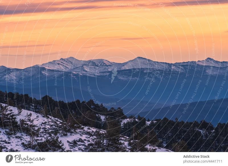 Picturesque landscape of snowy mountains under bright sky at sunset slope nature rocky highland ridge peak breathtaking range hill picturesque sunlight sunrise