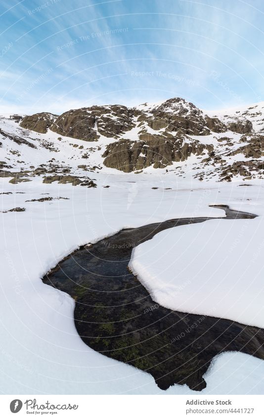 Snowy slope of hill in daytime snow mountain highland nature winter landscape environment terrain dirty ridge valley scenery cloudy cold hillside frozen frost