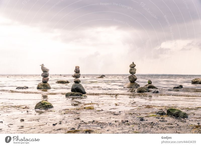 Stone towers on the beach stones stone tower spires Baltic Sea Beach Deserted Sky Landscape Ocean Nature coast Water Exterior shot Waves Clouds Colour photo