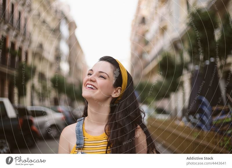 Charming woman walking on the street charming personality style cool millennial posture appearance female cheerful feminine individuality brunette carefree