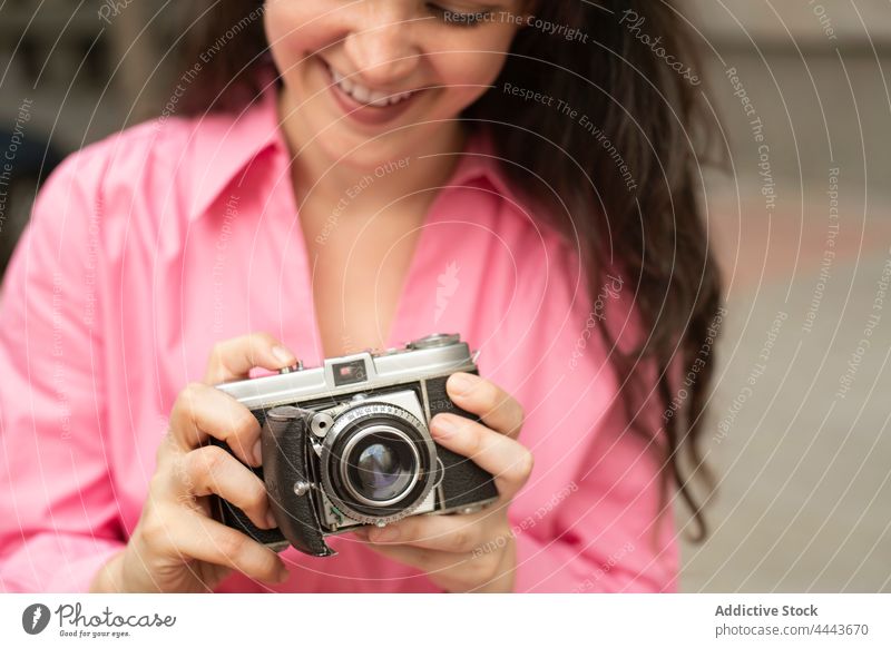 Young woman taking photo on vintage camera take photo photo camera moment classic capture focus lens retro female memory building street long hair old fashioned