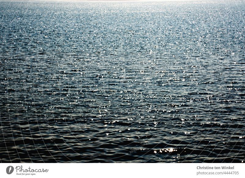 The North Sea glitters in the morning sun in calm weather, there is only water to be seen Ocean Water Waves Sunlight sparkle Beautiful weather Day