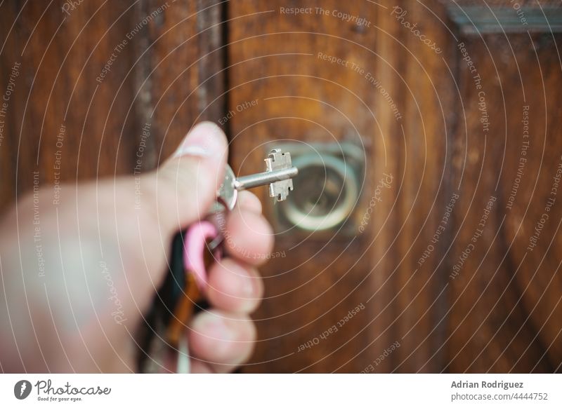 Door of a rural hotel room, with the key in the lock. access apartment door entrance estate hosting housing inside no people open privacy rent secure interior