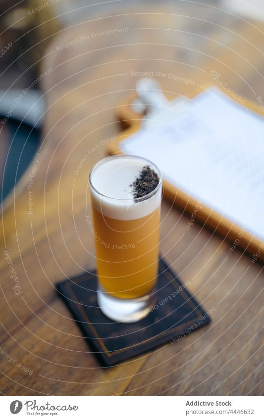 Glass of cold cocktail on table in bar egg white glass drink portion froth booze serve beverage pub foam counter wooden alcohol service glassware taste liquid