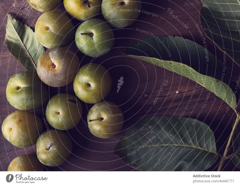 Fresh green plums placed on wooden table fresh vitamin organic healthy food leaf natural fruit plant delicious nutrition raw yummy edible season nutrient