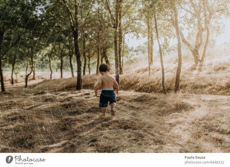 Rear view child walking Child Walking soil Dirty explore Authentic Happy Day Colour photo Lifestyle Infancy Leisure and hobbies Nature Exterior shot Human being