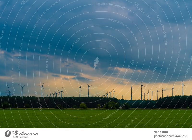 Wind turbines on a cloudy day wind turbines wind power green power electricity power generation clouds sky landscape wind farm wind energy power grid