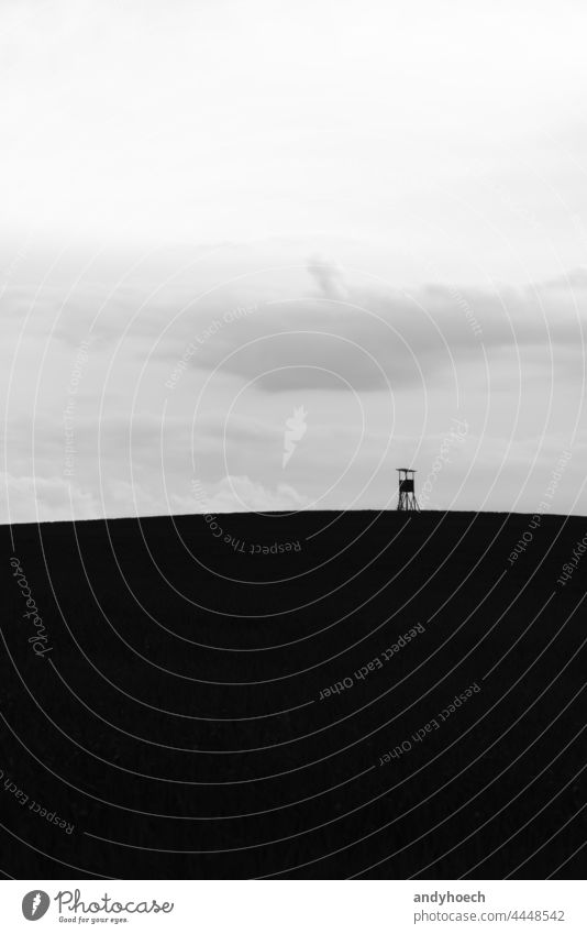 The high seat on a hill in the field abstract Art beautiful black black and white BW clouds contrast copy space day deer stand design environment european fauna