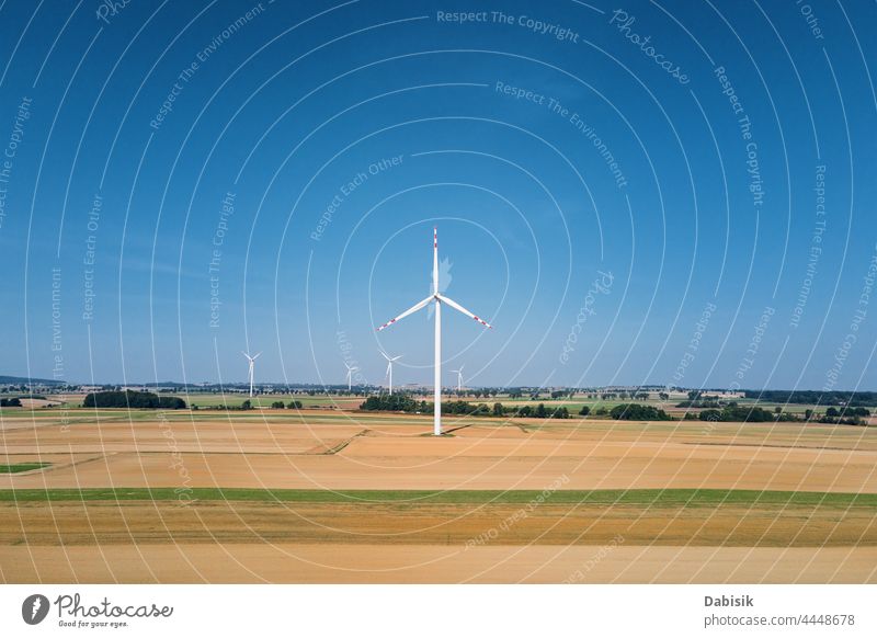 Windmill turbine in the field at summer day. Rotating wind generator energy windmill technology propeller sustainable landscape eco electric concept industry