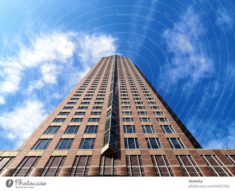 Granite facade in front of a blue sky in the sunshine of the MesseTurm at the exhibition grounds in the West End of Frankfurt am Main in Hesse, Germany