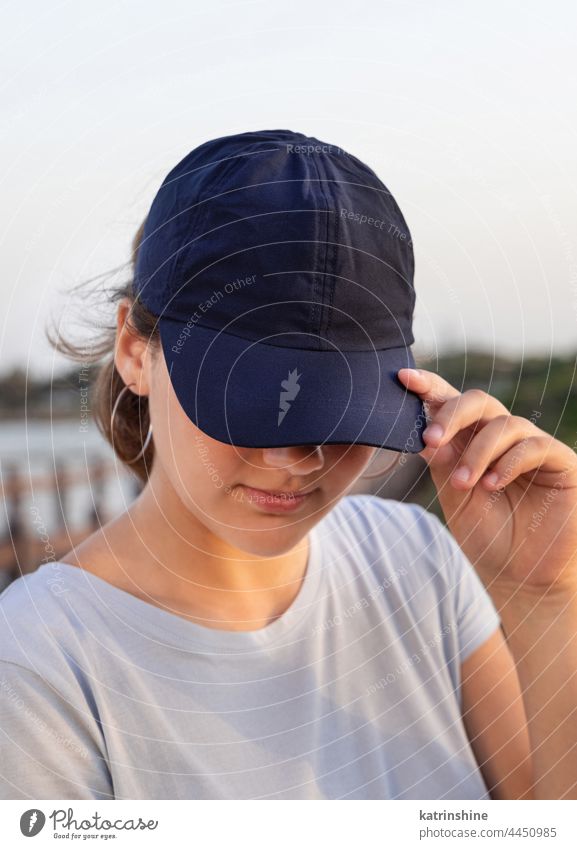 Teen girl in dark blue baseball cap and t-shirt outdoor teenager adolescent Caucasian mockup sea visor wearing t-shirts teen girl childhood female happiness