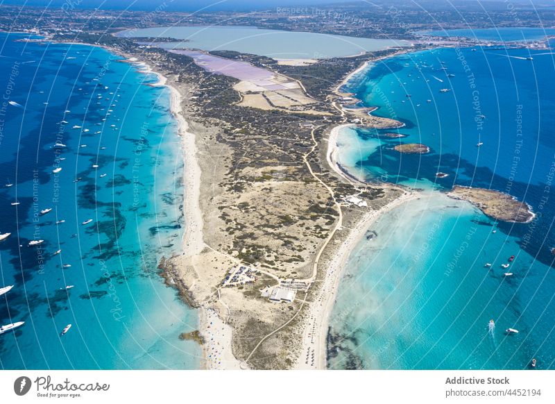 Island between sea with motorboats in summer island ibiza coast nature landscape environment ecology sail transport yacht water nautical shore seaside spain