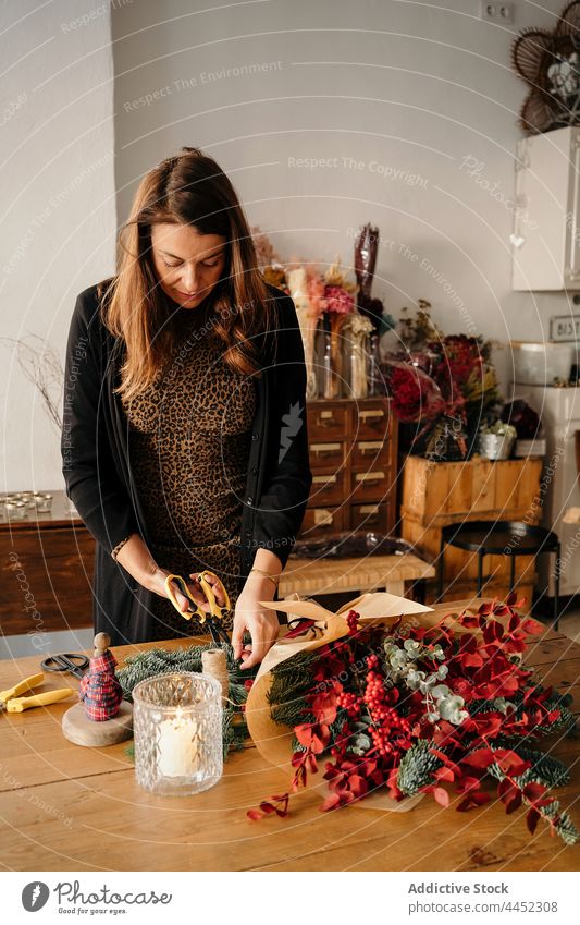 Female florist making bouquet in floristry studio woman flower arrange floral workshop female bloom blossom workplace compose handicraft table create occupation