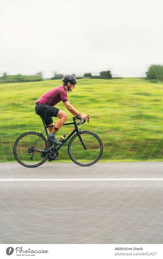 Bicyclist riding bike during training on countryside road bicyclist ride sport racing bicycle cycling workout activity man route direction road bicycle