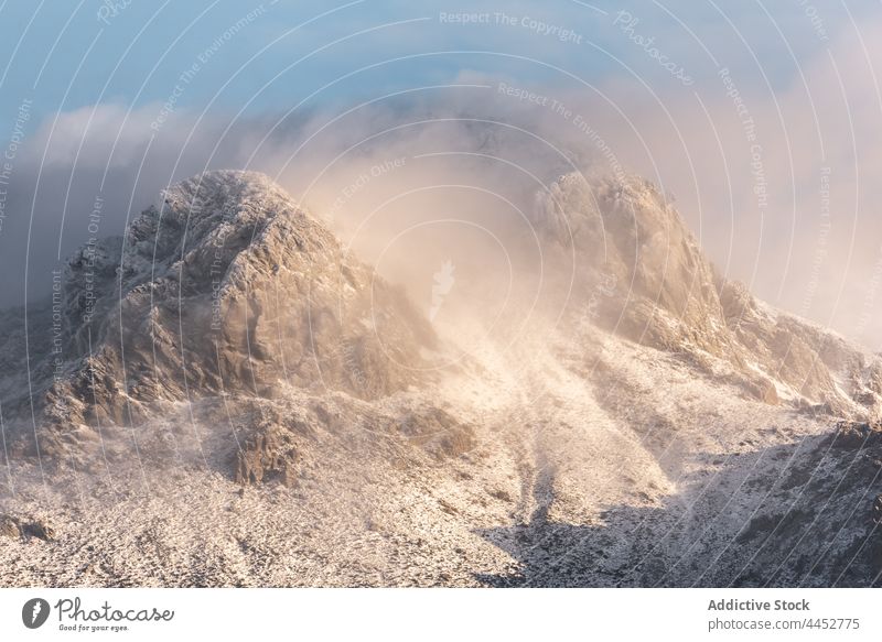 Snowy mountain slope under clouds in winter day snow steep cold nature landscape range highland frost rock wild formation scenery altitude stone wildlife ridge