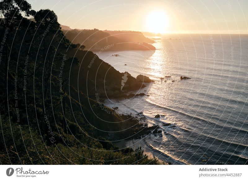 Wavy sea against mountains under shiny sky at sunset nature seascape landscape highland horizon wavy sundown ocean ripple seawater marine endless massive