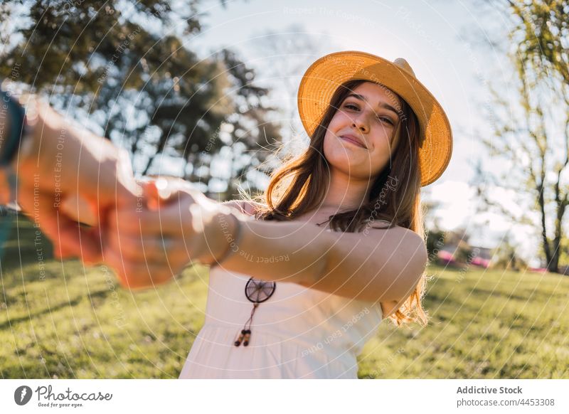 Cheerful teen holding crop friend by hand on meadow holding hands follow me cheerful spend time interact sincere portrait together partner smile candid content