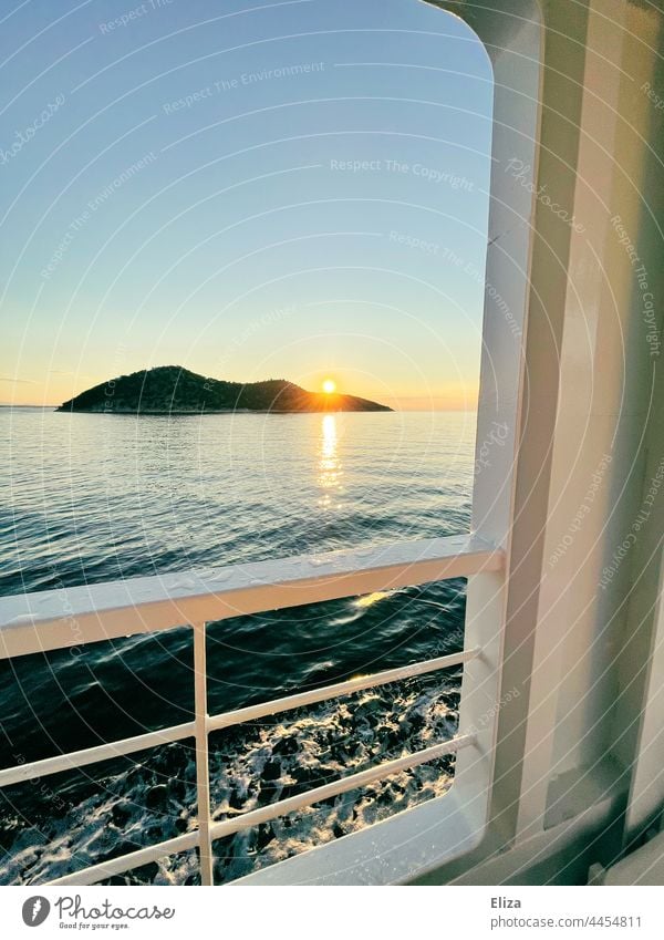 View of a small island in the sea and the sunrise from a ship Ocean Island Sunrise Railing Ferry Water Navigation Waves Horizon Far-off places go away