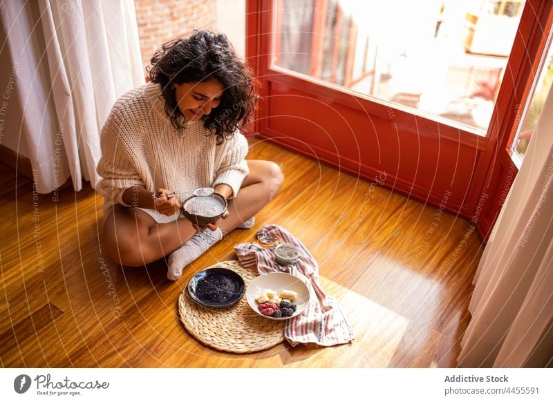 Woman eating healthy berries with chia seeds for breakfast woman raspberry blueberry portion diet super food healthy food nutrition female homemade yummy ripe