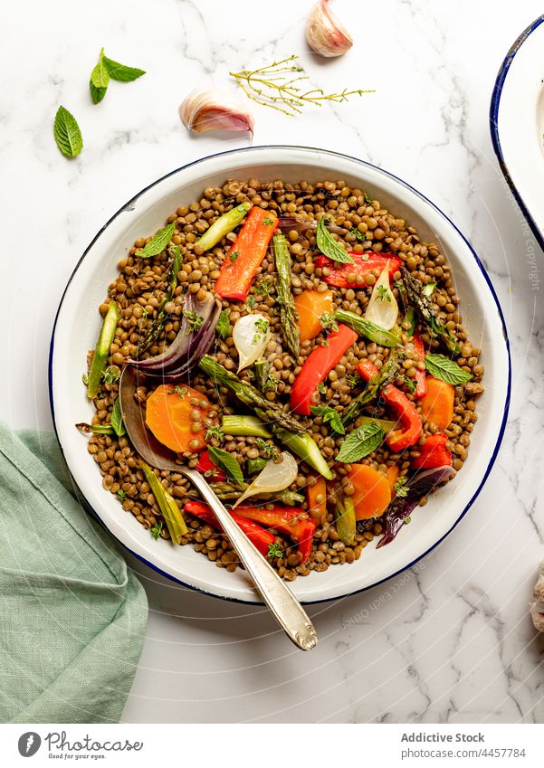 Bowl with tasty lentil salad on table dish lunch healthy food bowl vegetable meal serve cuisine herb gourmet vegetarian vegan onion asparagus basil carrot