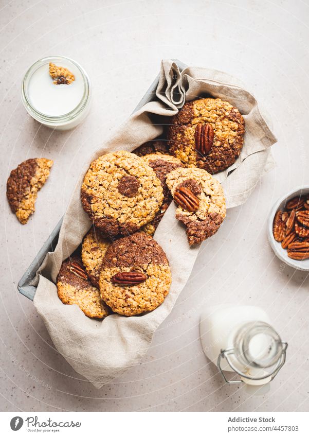 Cookies and milk served on table cookie walnut biscuit tasty dessert bottle sweet snack glass food delicious fresh pastry breakfast sugar nutrition homemade