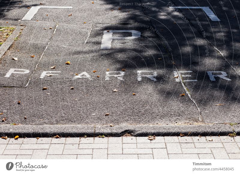 Priest - reserved parking space Parking lot Reserved Pastor Signs and labeling Characters Deserted asphalted Street Paving stone Shadow Asphalt Gray