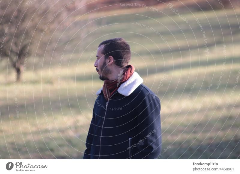 young man looks into the distance whistling Man Young man Whistle To go for a walk out Nature chill Autumnal winter Winter Cold be out Meditative by oneself