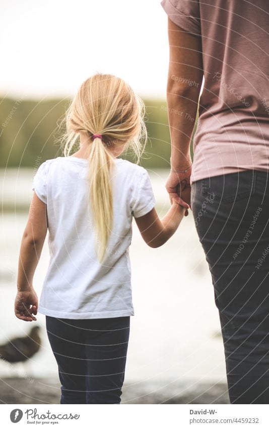 Mother and daughter hand in hand Child hands To hold on at the same time proximity Trust stop Love Safety (feeling of) Parents Together Hold hands