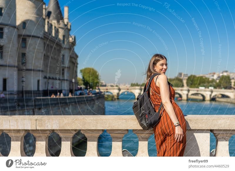 Female tourist in front of Sainte Chapelle in Paris Seine River Backpack woman France tourism travel hiking contemplating city urban young culture sightseeing