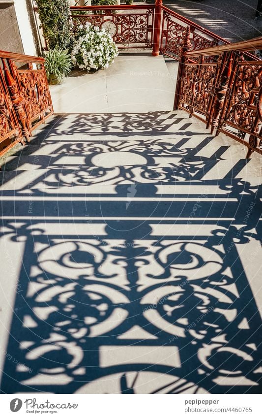 Shadow from a rusty railing on a staircase Shadow play Dark side Shadowy existence shadow cast shade dispenser handrail shadow Exterior shot Colour photo