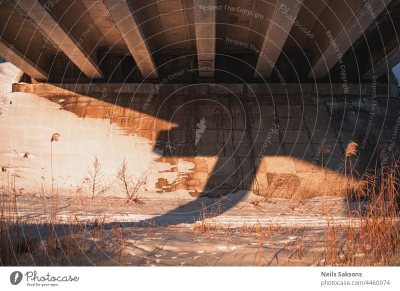 Reinforced concrete structure of highway overpass. view from bottom down. Cracking of concrete beams under the bridge abstract architecture below building