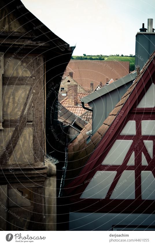 Two old half-timbered houses stand very close to each other. No pram fits between them. Half-timbered house Deserted Colour photo Old town