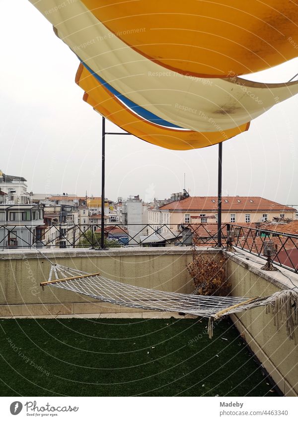 Hammock with awning on the roof terrace of a hotel in the old town of Taksim in summer at the Istiklal Caddesi in the Beyoglu district of Istanbul on the Bosporus in Turkey