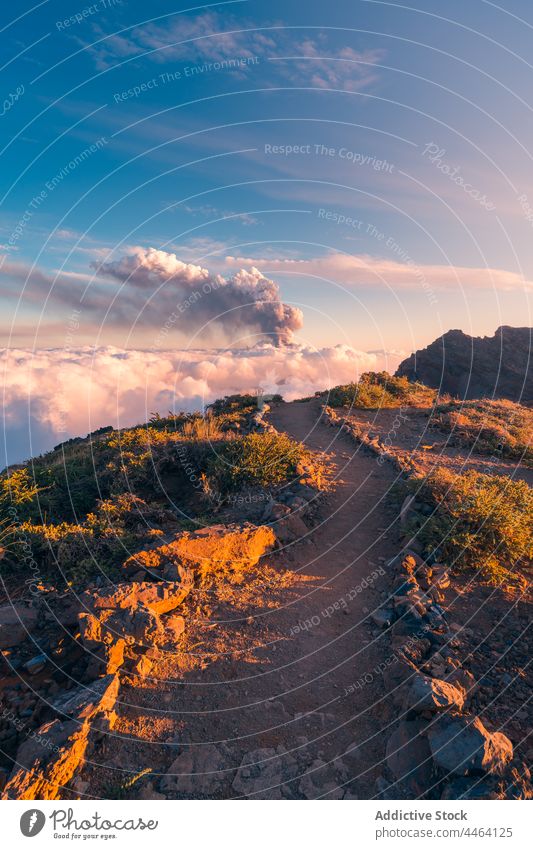 Peaks amidst clouds and volcano in the background mountain peak top summit sunrise black cloud sea of clouds nature sky environment hill ridge view idyllic high