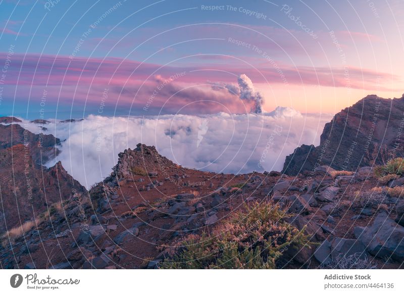 Peaks amidst clouds and volcano in the background mountain peak top summit sunrise black cloud sea of clouds nature sky environment hill ridge view idyllic high