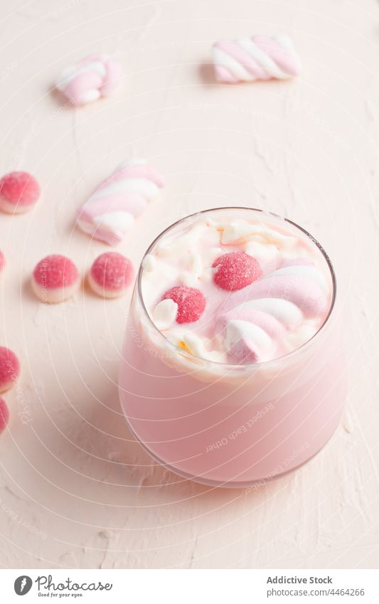 Glass of hot white chocolate jelly candy sweet drink marshmallow dessert delicious food confectionery yummy sugar tasty pink color flavor calorie glass