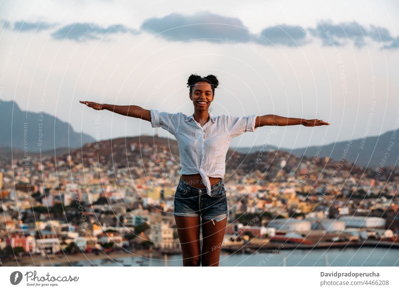 Woman looking at a beautiful city landscape woman watching happy Cape Verde monte cara Sao Vicente enjoying unrecognizable black vacation african coast island