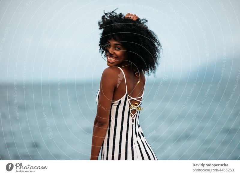 Woman in a volcanic beach woman ethnic island seaside beautiful santo antao smile african cape verde holiday horizontal happy black curly hair looking at camera