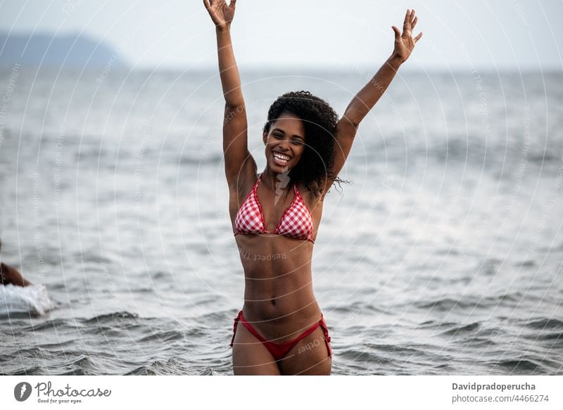 Woman in bikini in a volcanic beach woman ethnic island seaside beautiful fit santo antao smile african sexy cape verde holiday horizontal happy black